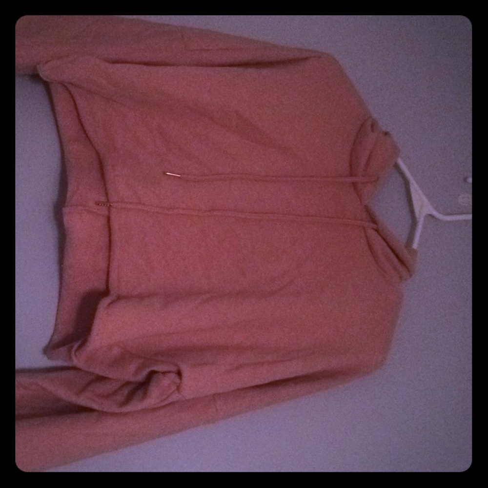 A pink cropped hoodie